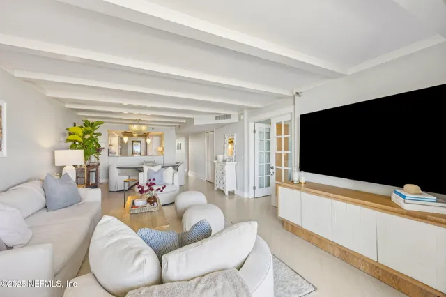 a bedroom with a large bed and a tv