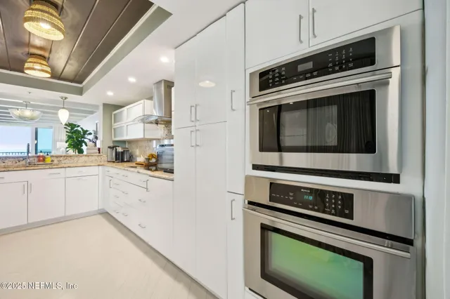 a kitchen with granite countertop a stove and a sink