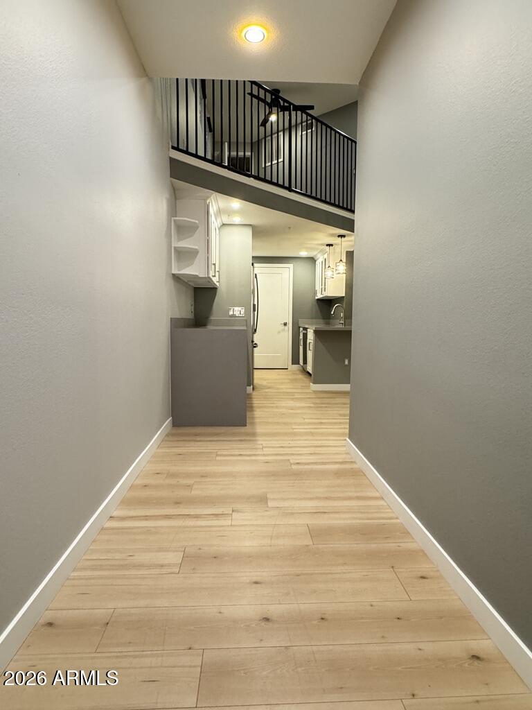 a view of a hallway with wooden floor and staircase