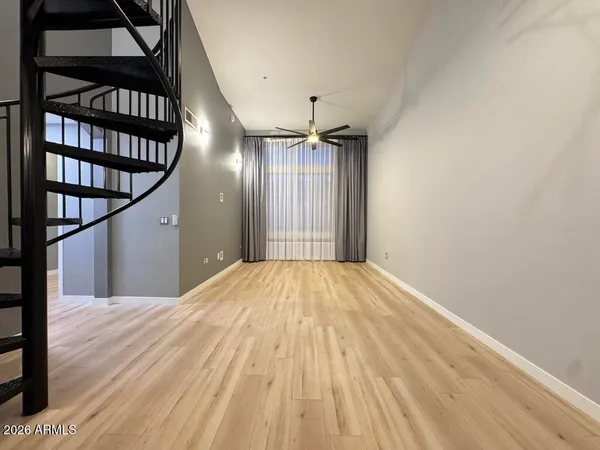 a view of empty room with wooden floor