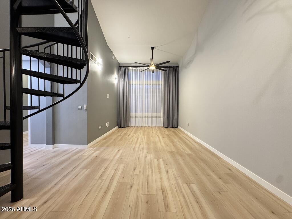 1701 East Colter Street, Unit 431 Phoenix, AZ 85016 - Photo 12 of 23 a view of a hallway with wooden floor and staircase