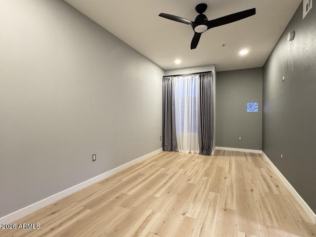 1701 East Colter Street, Unit 431 Phoenix, AZ 85016 - Photo 13 of 23 a view of a room with a ceiling fan and hardwood floor