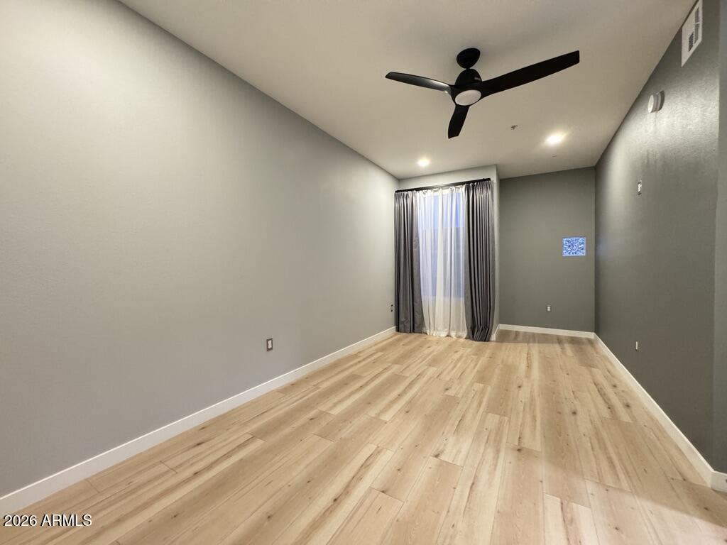 1701 East Colter Street, Unit 431 Phoenix, AZ 85016 - Photo 14 of 23 a view of empty room with wooden floor