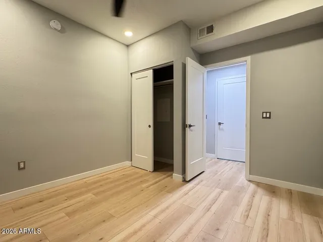 a view of an empty room with wooden floor