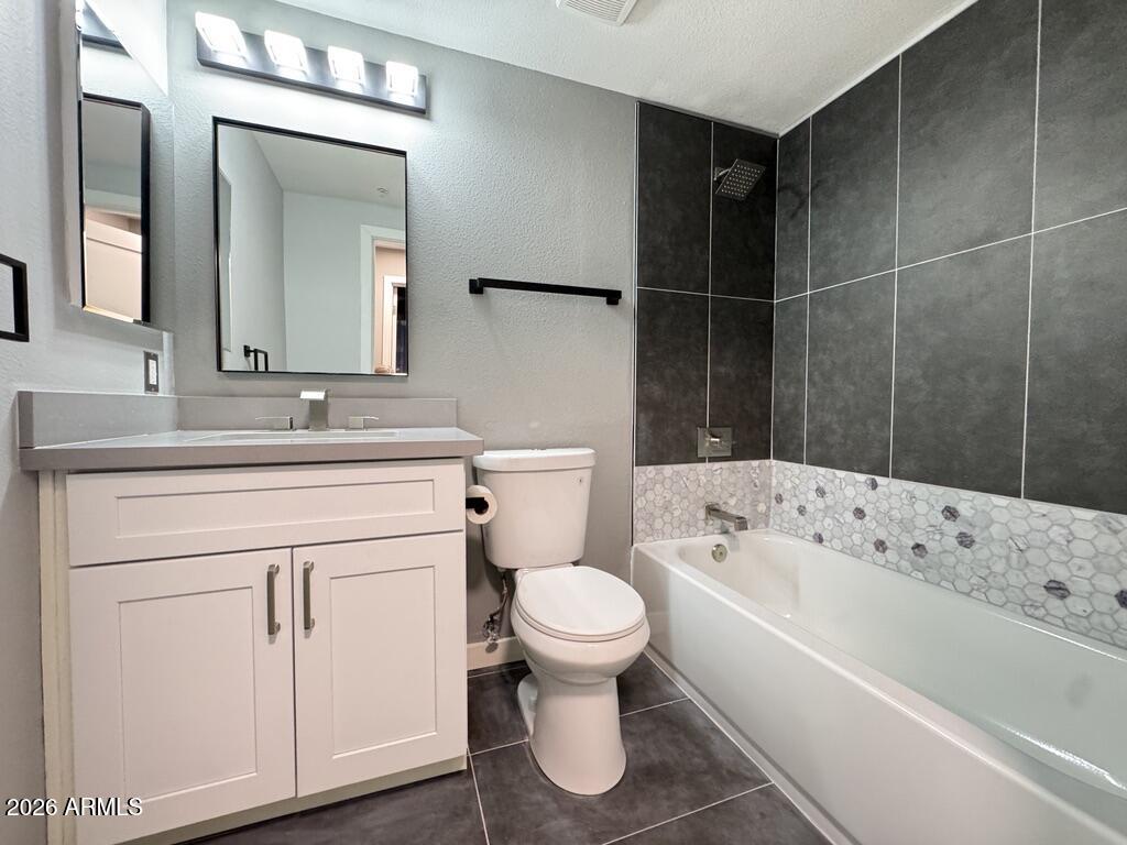1701 East Colter Street, Unit 431 Phoenix, AZ 85016 - Photo 20 of 23 a bathroom with a sink toilet vanity and bathtub