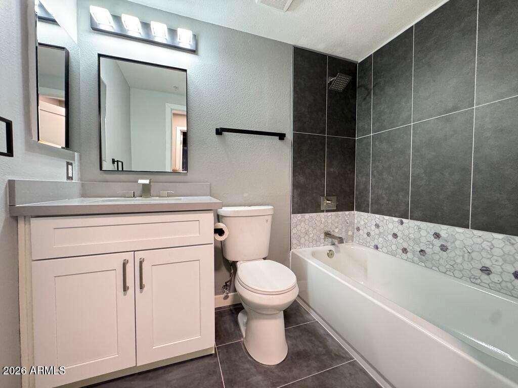 1701 East Colter Street, Unit 431 Phoenix, AZ 85016 - Photo 20 of 23 a bathroom with a sink toilet vanity and bathtub