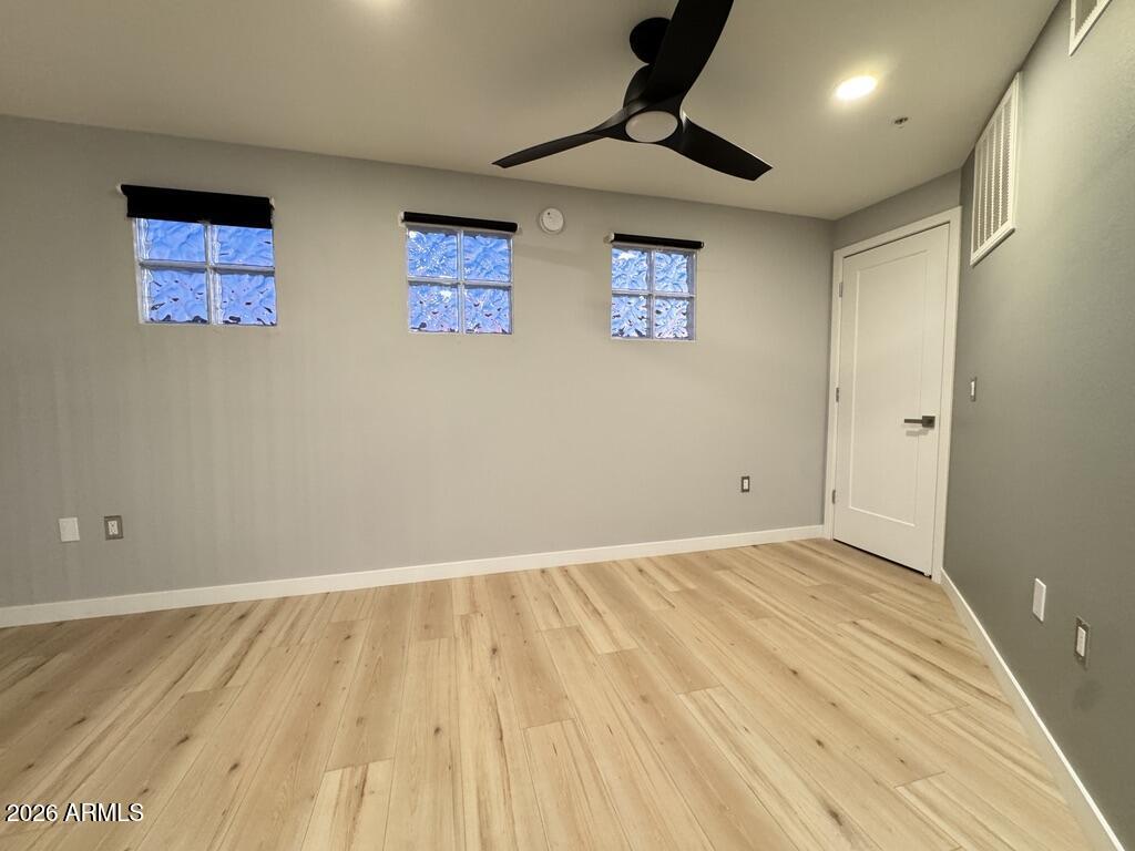 1701 East Colter Street, Unit 431 Phoenix, AZ 85016 - Photo 22 of 23 a view of an empty room with wooden floor