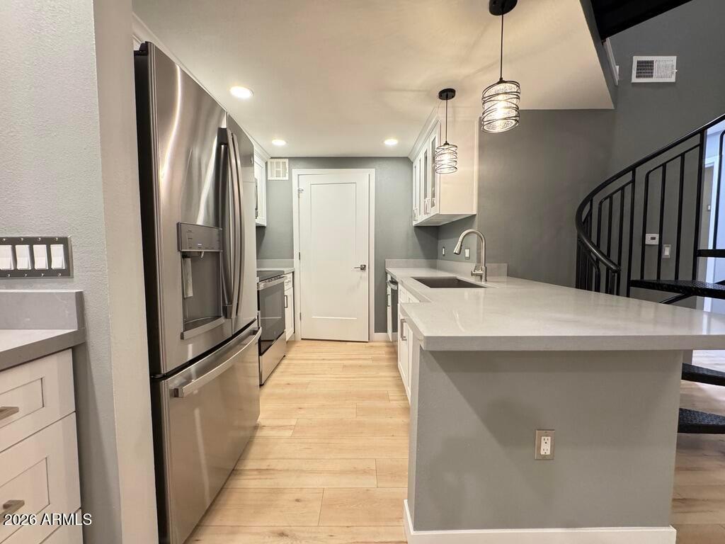 1701 East Colter Street, Unit 431 Phoenix, AZ 85016 - Photo 4 of 23 a kitchen with stainless steel appliances a refrigerator and a counter top space