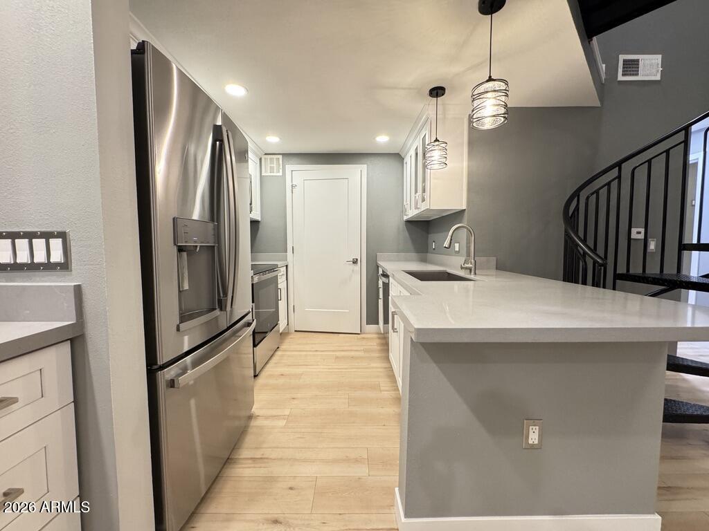1701 East Colter Street, Unit 431 Phoenix, AZ 85016 - Photo 4 of 23 a kitchen with stainless steel appliances a refrigerator and a counter top space