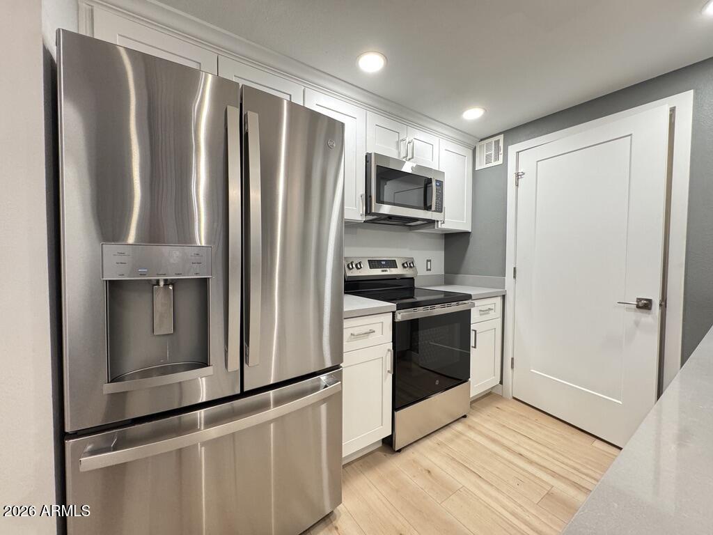 1701 East Colter Street, Unit 431 Phoenix, AZ 85016 - Photo 5 of 23 a kitchen with stainless steel appliances a refrigerator sink and microwave