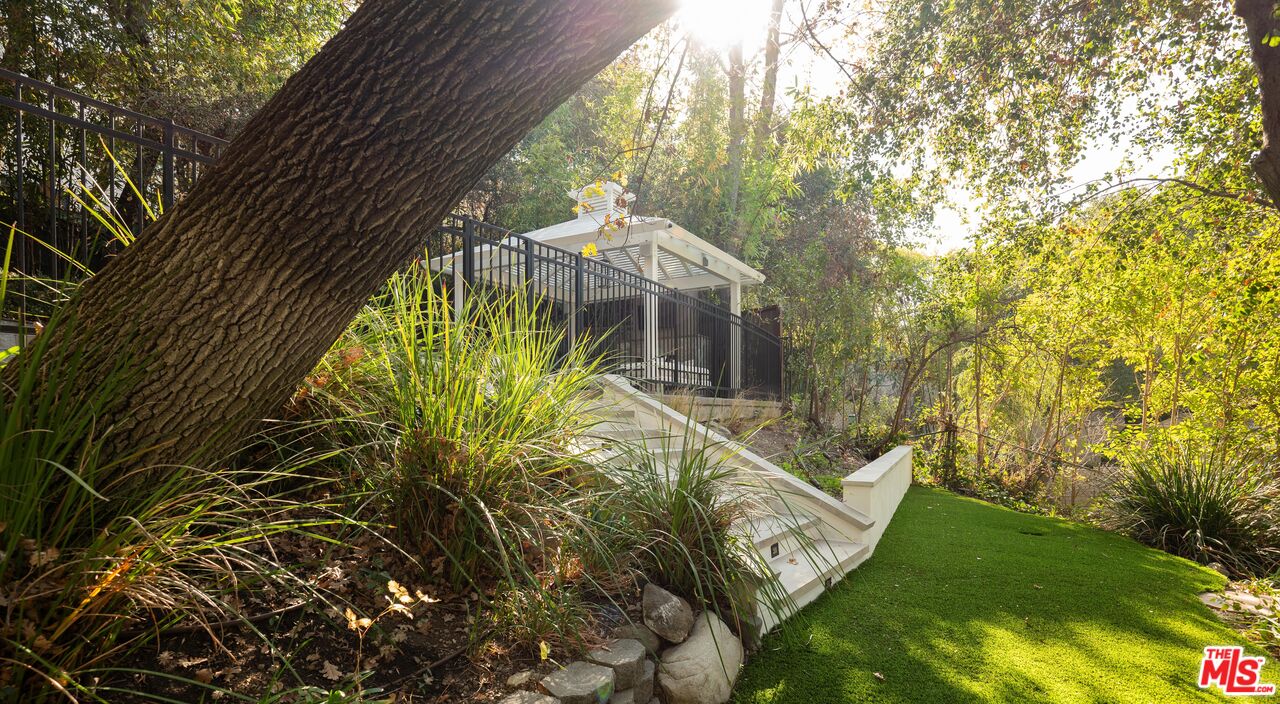 17204 Rancho Street Encino, CA 91316 - Photo 16 of 30 a view of a yard with plants and large trees