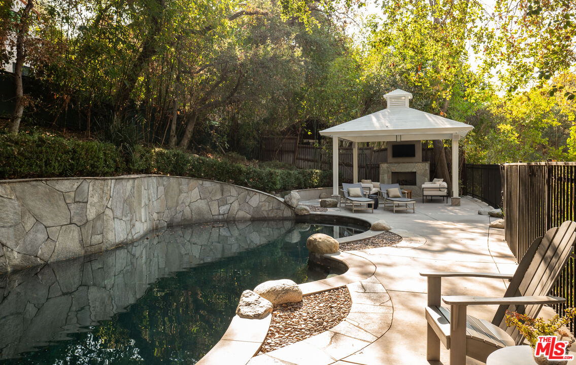 17204 Rancho Street Encino, CA 91316 - Photo 17 of 30 a view of a house with backyard water fountain and sitting area