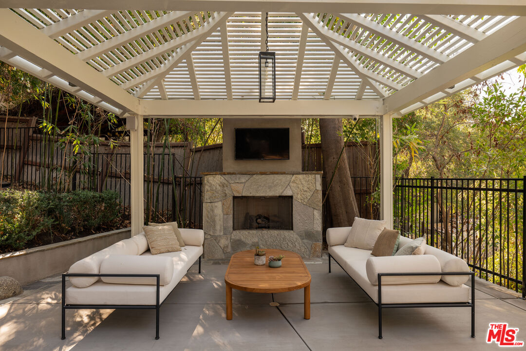 17204 Rancho Street Encino, CA 91316 - Photo 18 of 30 a outdoor living space with patio furniture and a fireplace