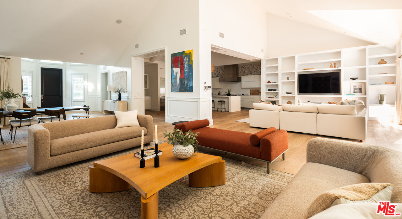 17204 Rancho Street Encino, CA 91316 - Photo 19 of 30 a living room with furniture a flat screen tv and a fireplace