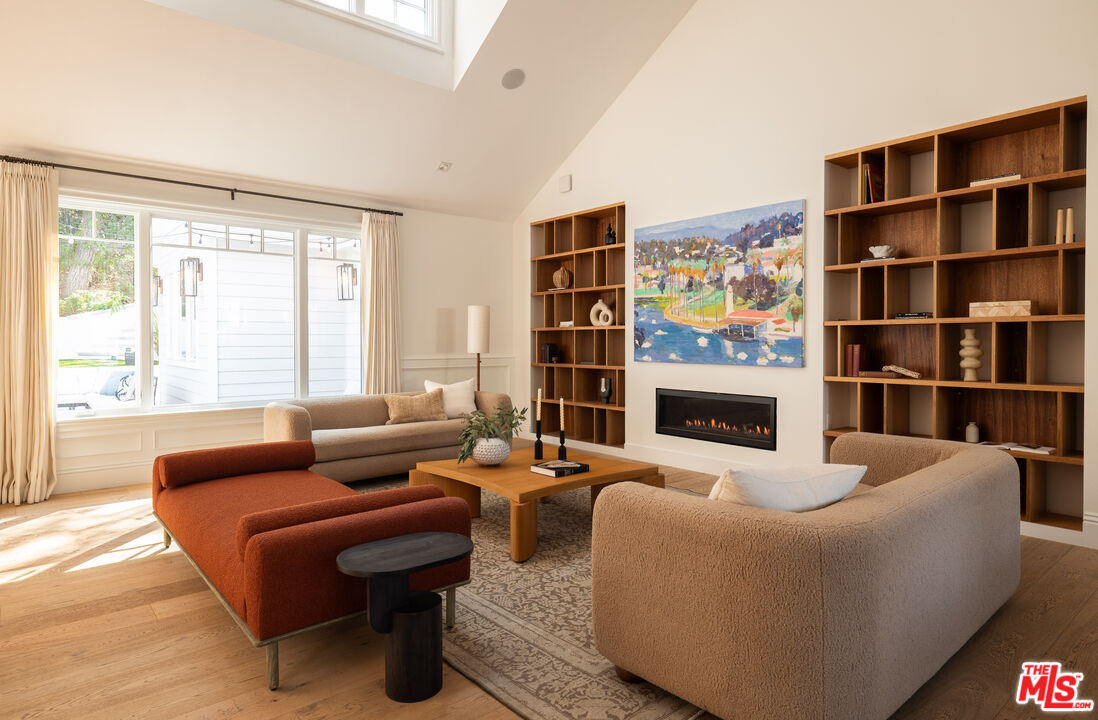 17204 Rancho Street Encino, CA 91316 - Photo 7 of 30 a living room with fireplace furniture and a large window