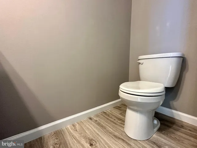 a white toilet sitting next to a small bathroom