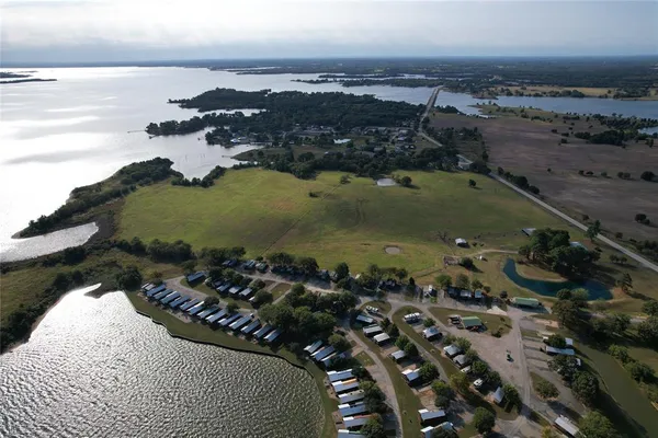 an aerial view of a residential houses with outdoor space