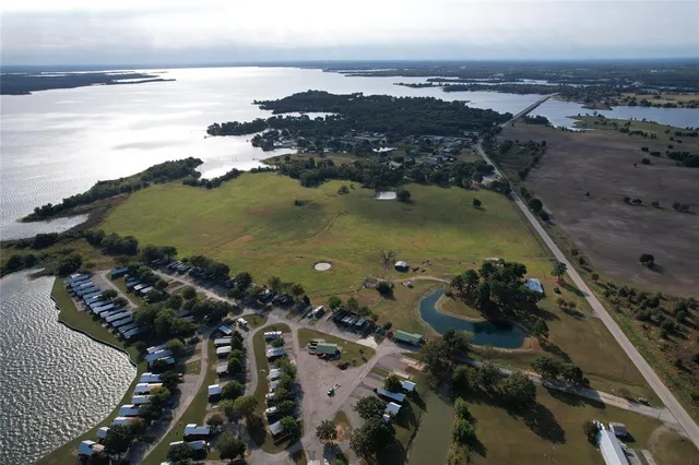 an aerial view of a houses with ocean view