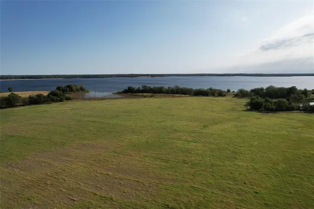 a view of a lake with houses in the back