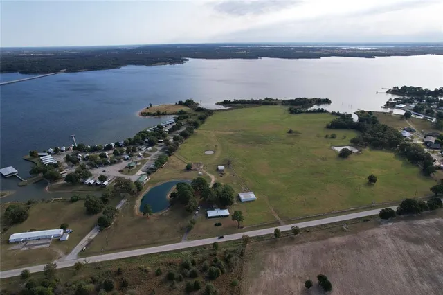an aerial view of a residential building ocean and trees in the background