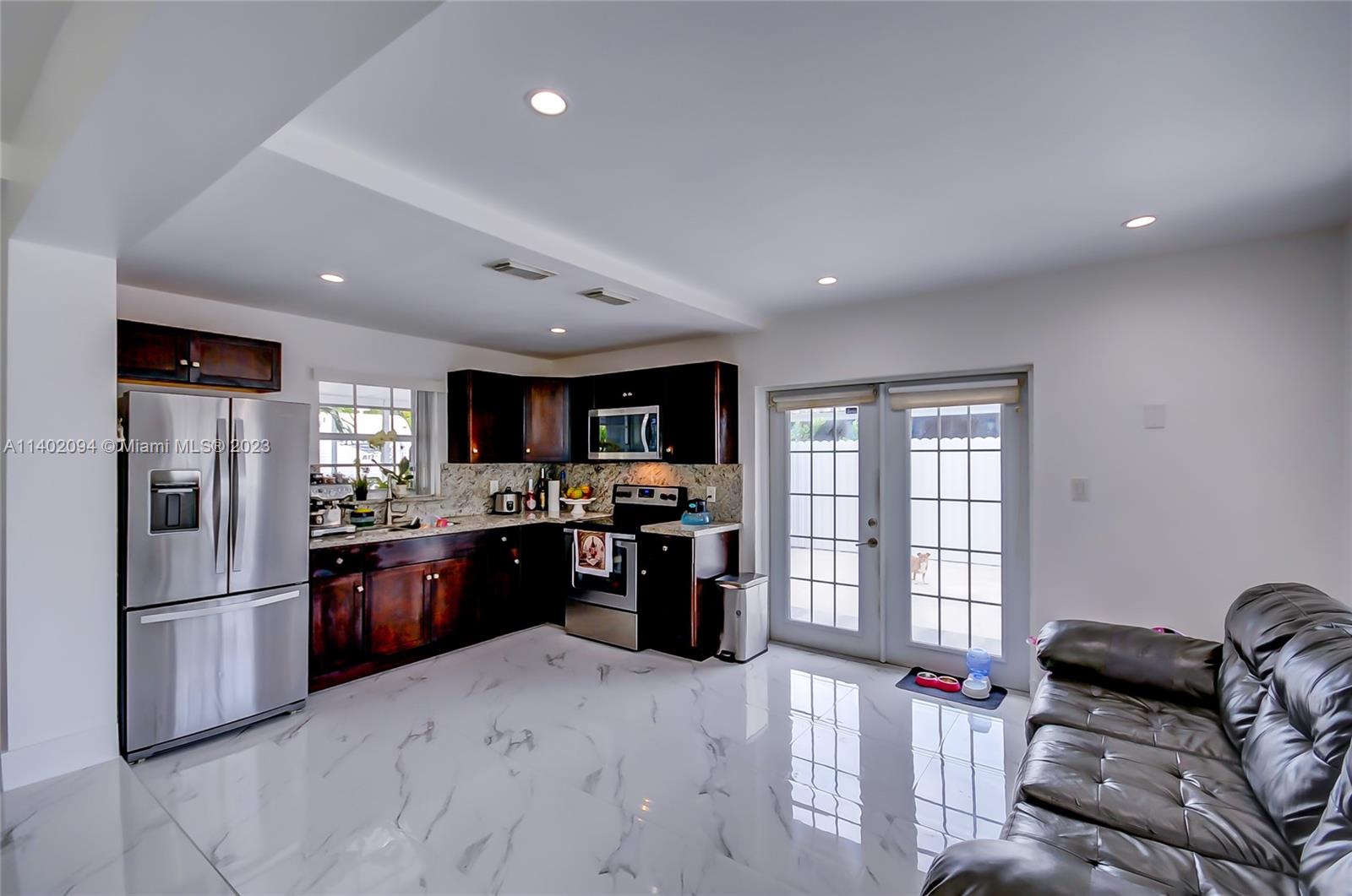 4260 Southwest 99th Avenue Miami, FL 33165 - Photo 1 of 36 a kitchen with stainless steel appliances granite countertop a refrigerator and a stove top oven