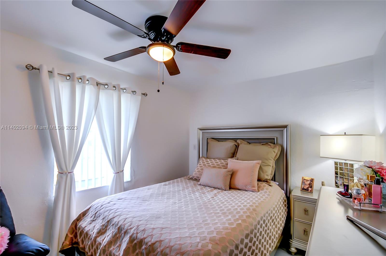 4260 Southwest 99th Avenue Miami, FL 33165 - Photo 11 of 36 a bedroom with a bed and a chandelier