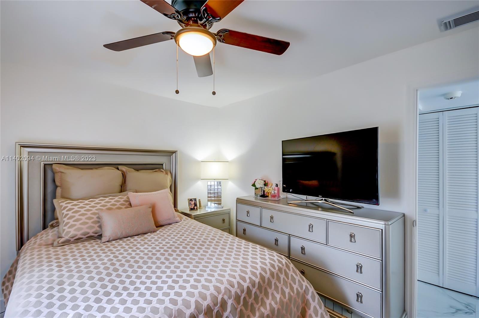4260 Southwest 99th Avenue Miami, FL 33165 - Photo 12 of 36 a bedroom with a large bed and a flat screen tv