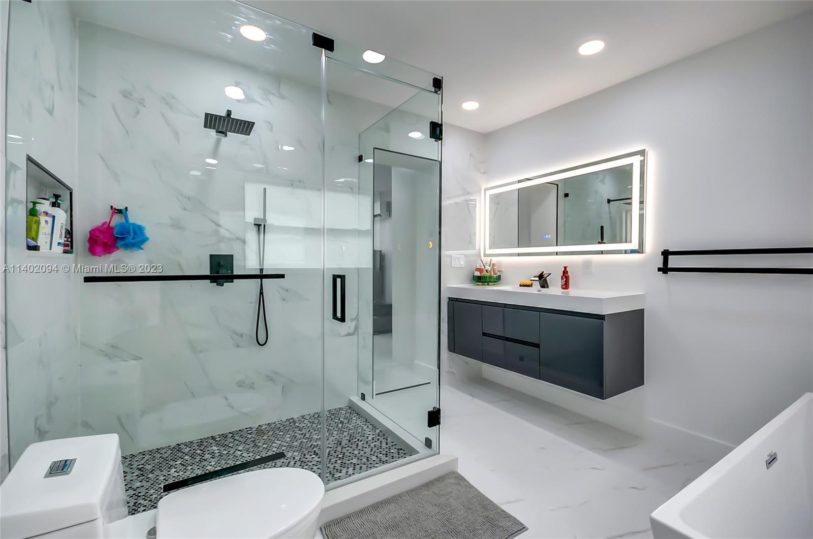 4260 Southwest 99th Avenue Miami, FL 33165 - Photo 16 of 36 a bathroom with a sink a toilet and shower