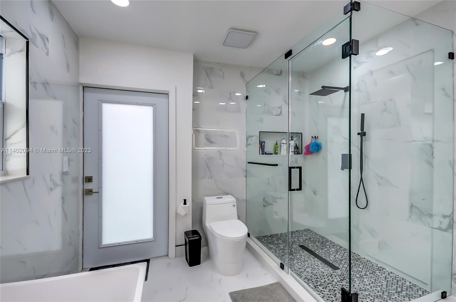 4260 Southwest 99th Avenue Miami, FL 33165 - Photo 17 of 36 a bathroom with a toilet and a shower