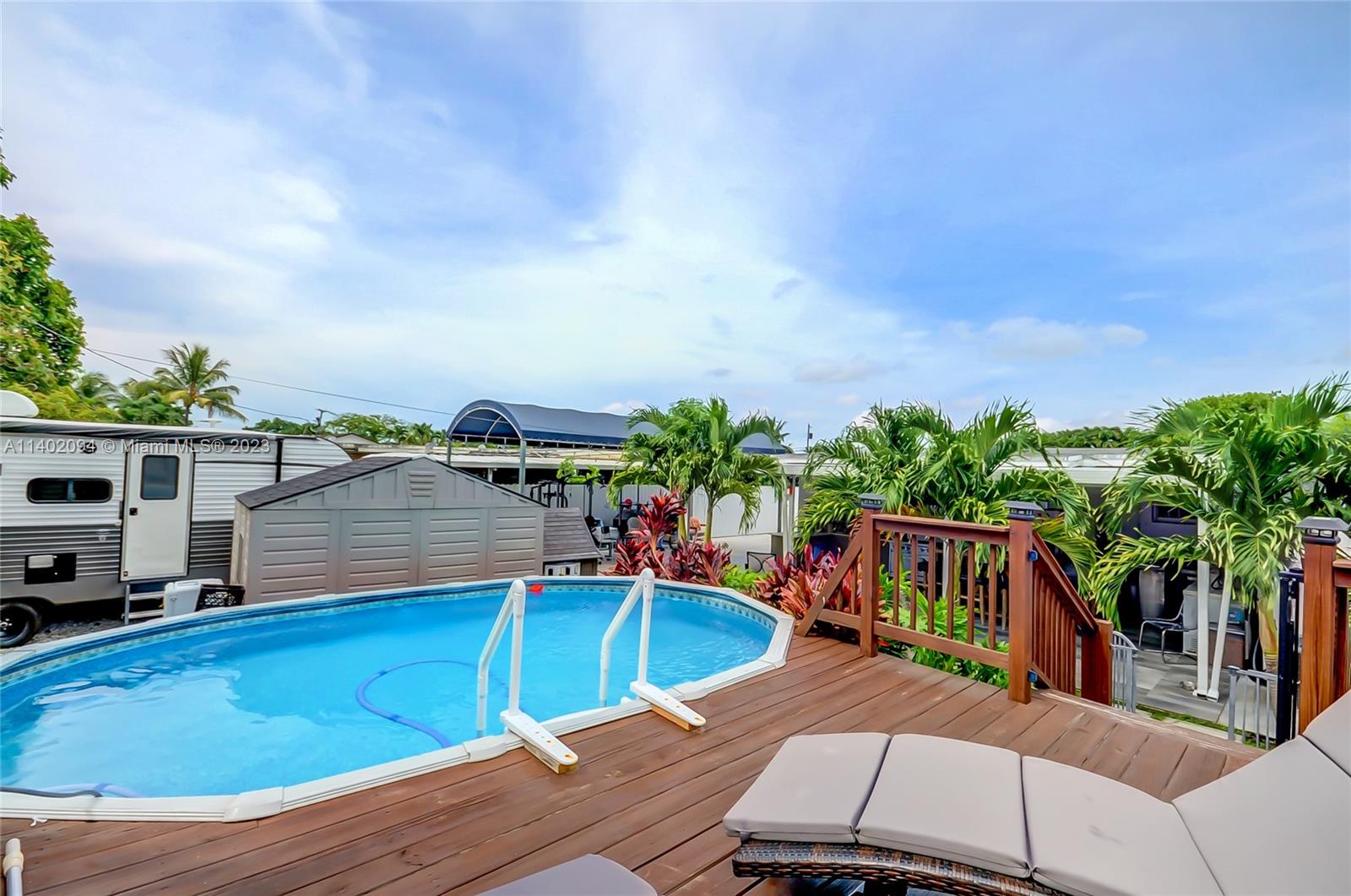 4260 Southwest 99th Avenue Miami, FL 33165 - Photo 21 of 36 a view of a chairs and table on the wooden deck