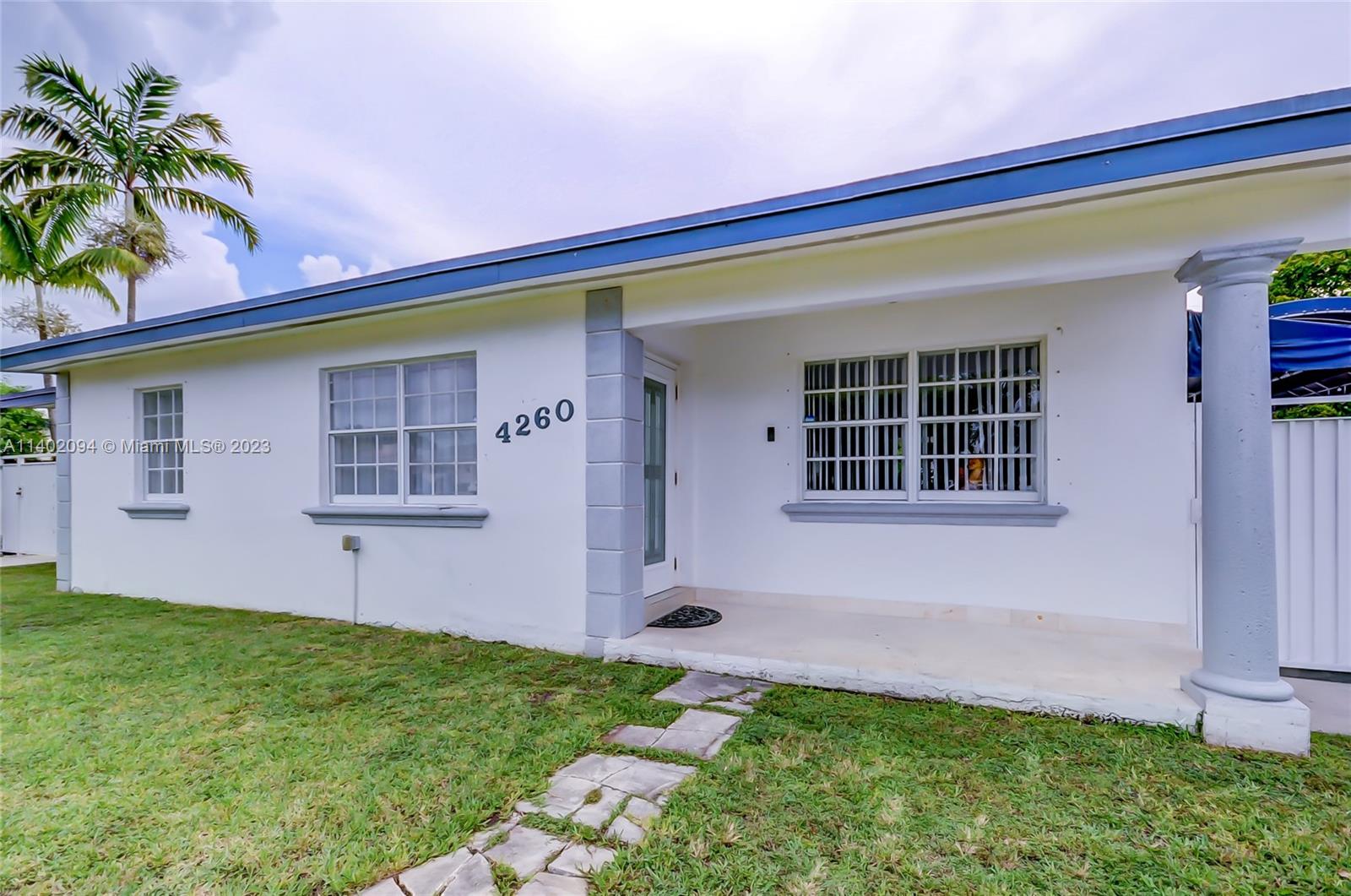 4260 Southwest 99th Avenue Miami, FL 33165 - Photo 32 of 36 a front view of a house with a yard and garage