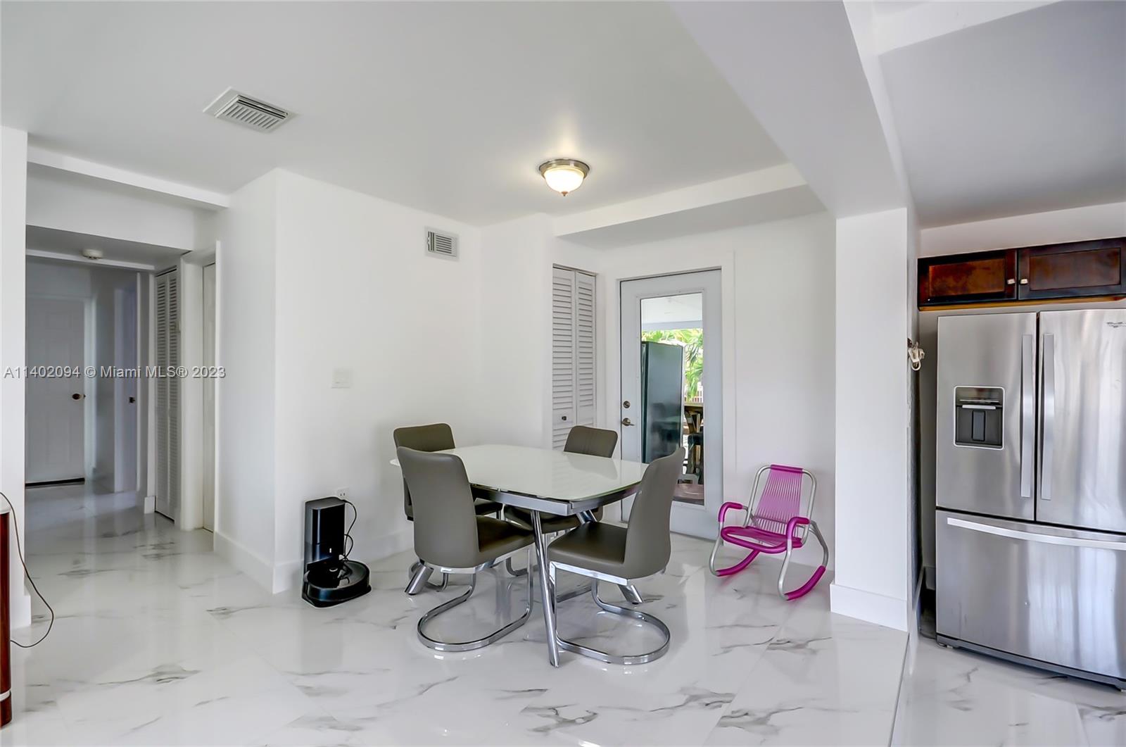 4260 Southwest 99th Avenue Miami, FL 33165 - Photo 5 of 36 a view of a room that has a couch and a refrigerator in it