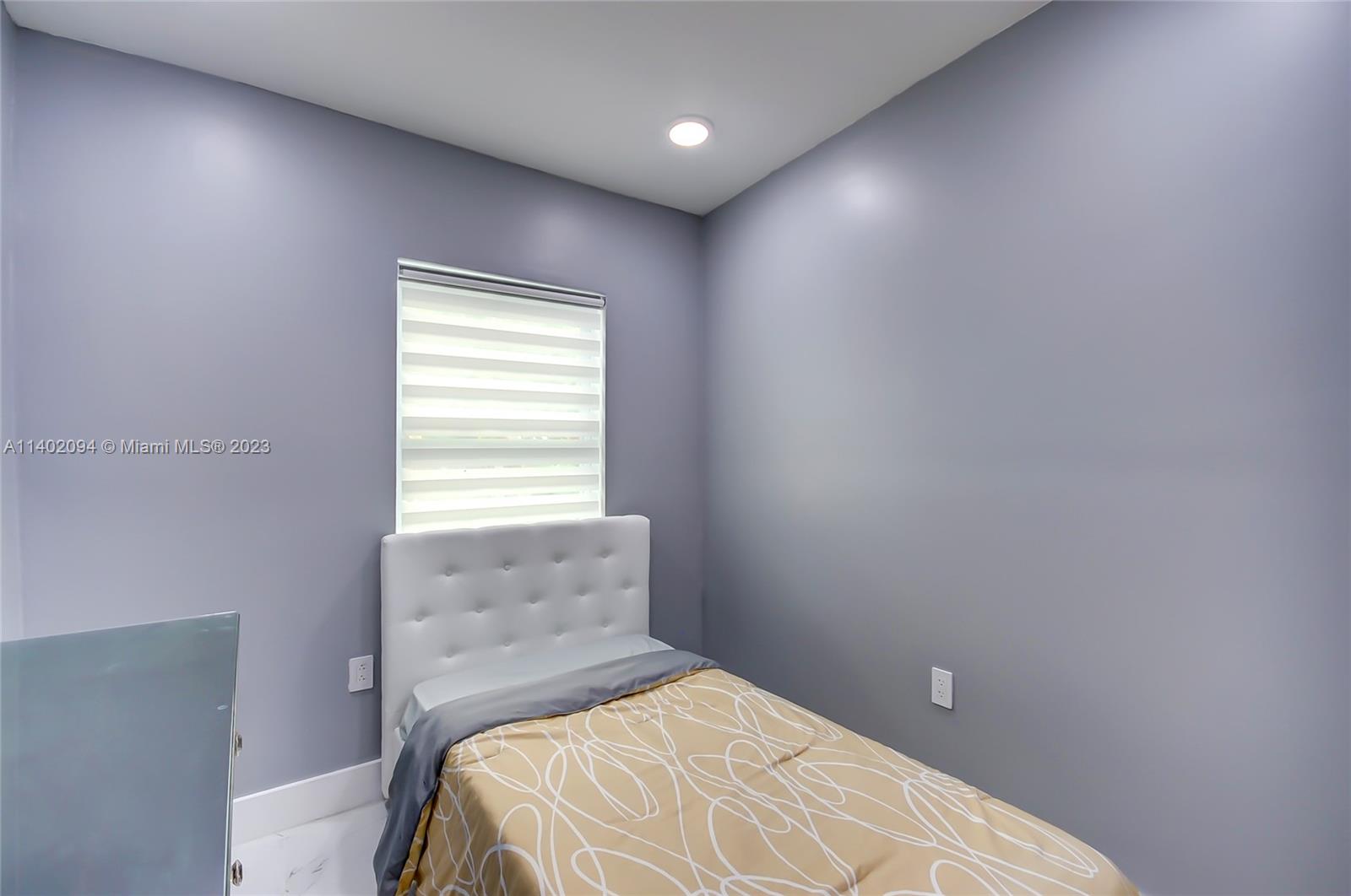 4260 Southwest 99th Avenue Miami, FL 33165 - Photo 8 of 36 a bedroom with a bed and a window