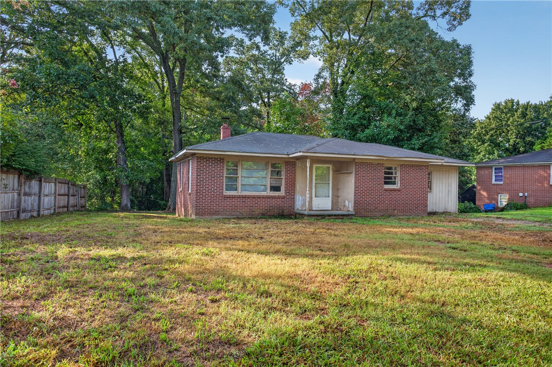 676 Marcengill Road Westminster, SC 29693 - Photo 2 of 32 Mature trees frame a classic brick exterior on a spacious grassy lot.