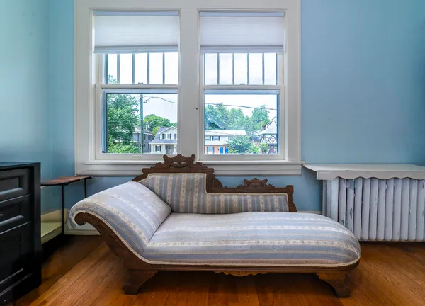 a bedroom with two beds and a window
