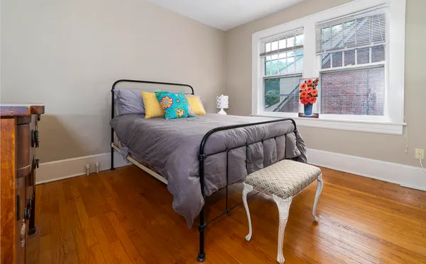 a bed sitting in a bedroom next to a window