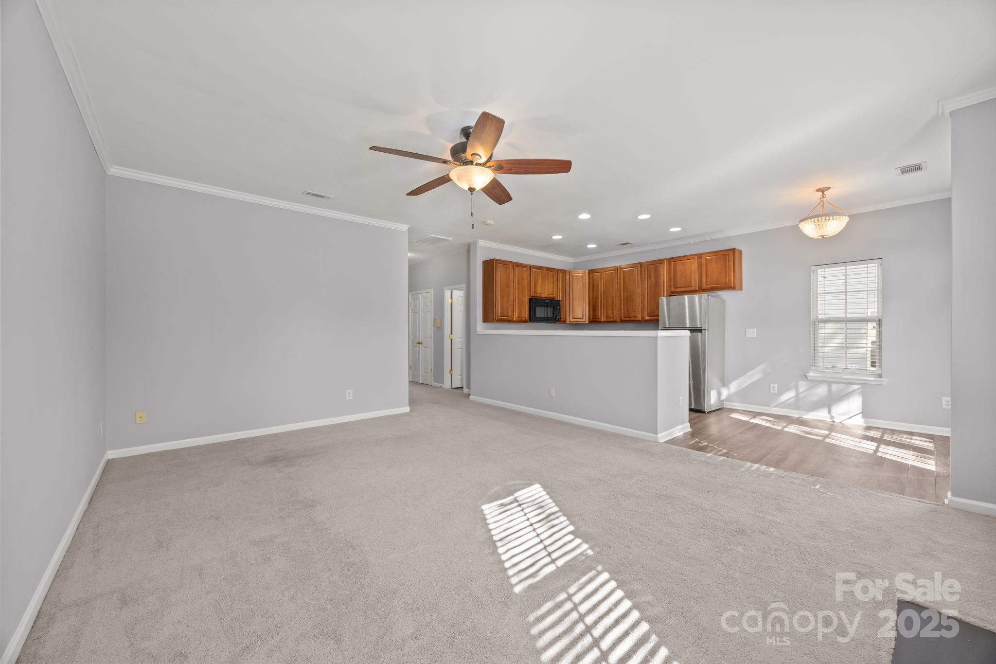 218 Tail Race Lane Fort Mill, SC 29715 - Photo 11 of 42 a view of a livingroom and a ceiling fan