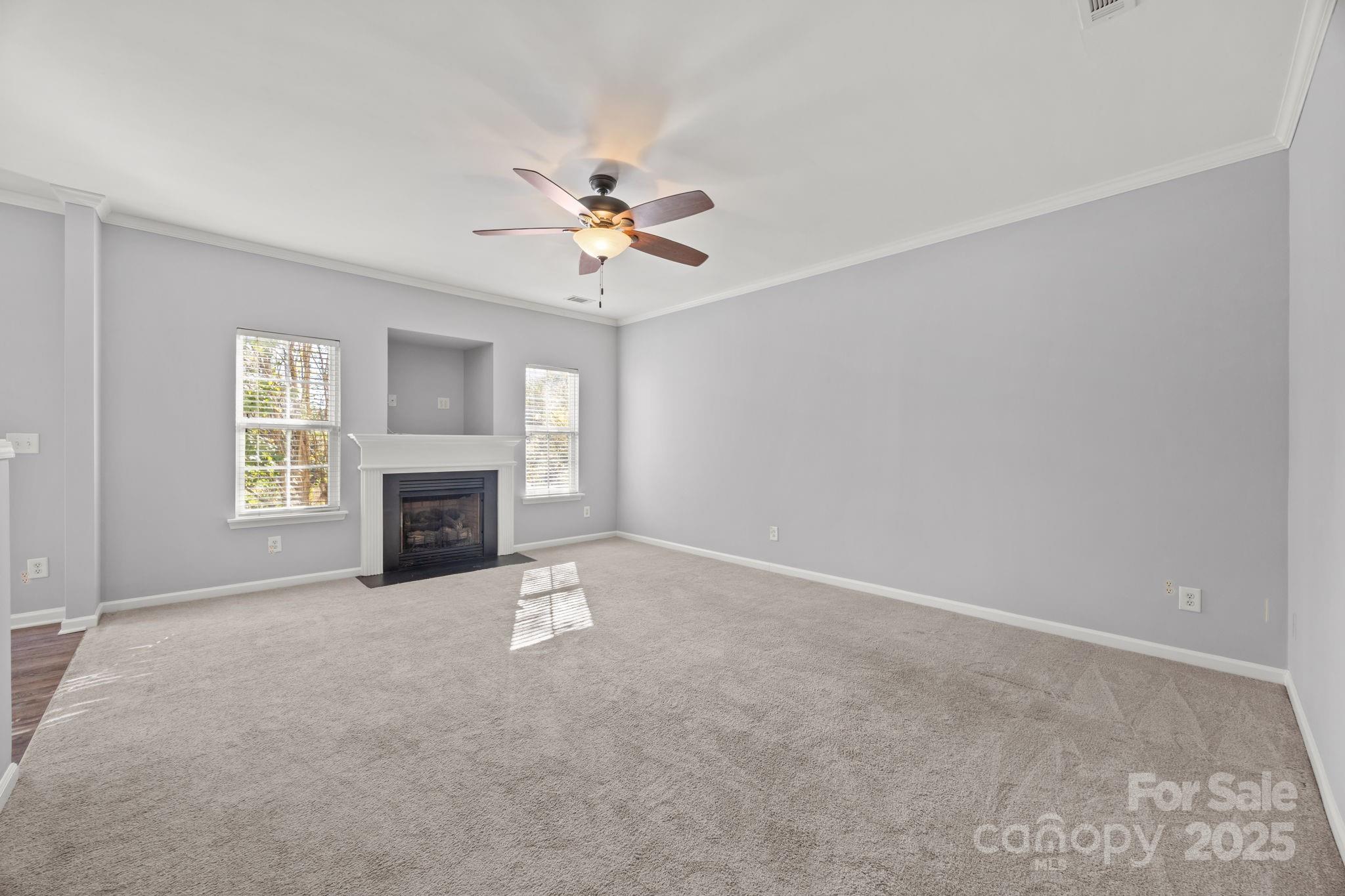 218 Tail Race Lane Fort Mill, SC 29715 - Photo 12 of 42 a view of empty room with fireplace and fan