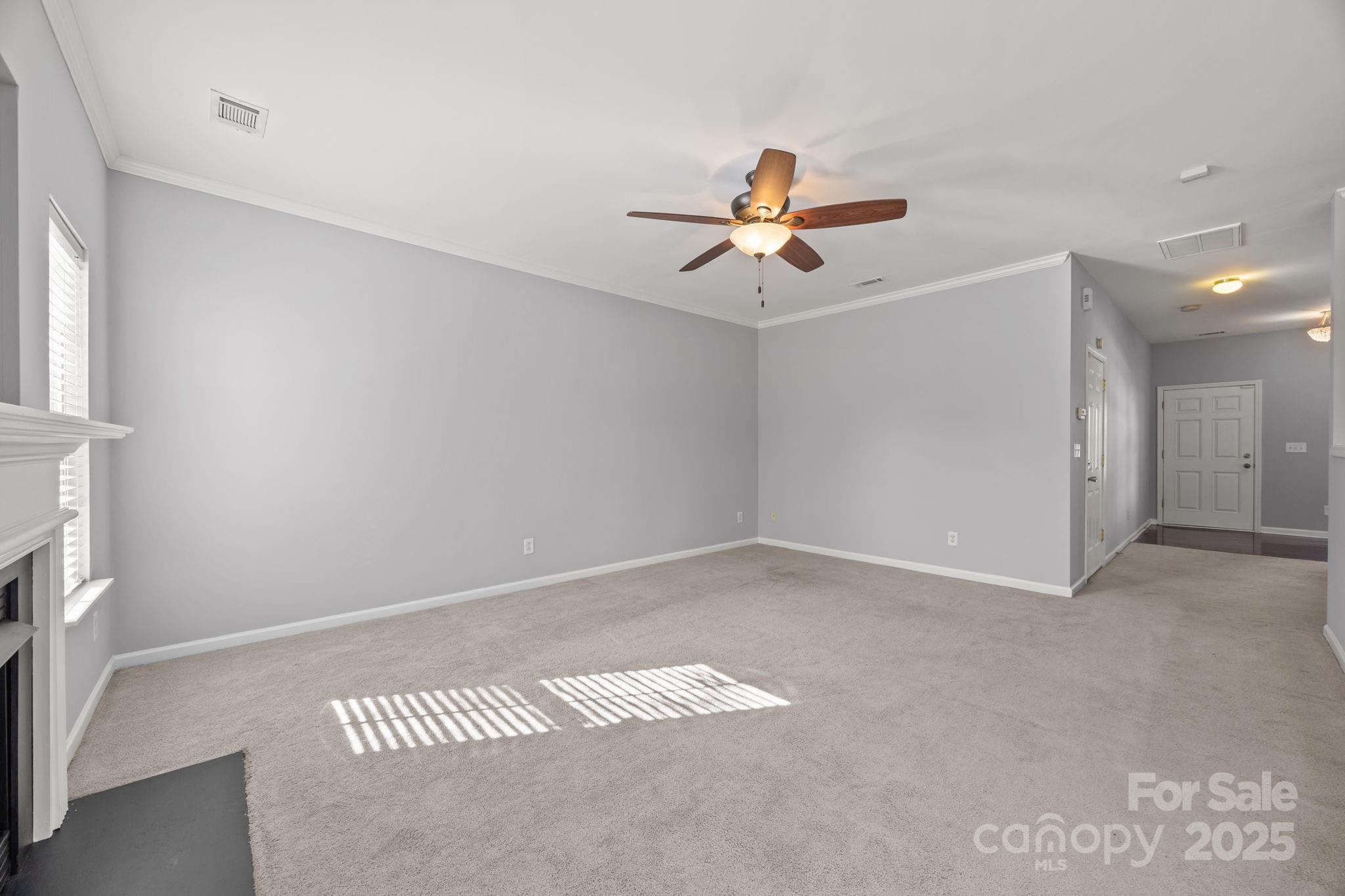 218 Tail Race Lane Fort Mill, SC 29715 - Photo 13 of 42 a view of a room with a ceiling fan and hardwood floor