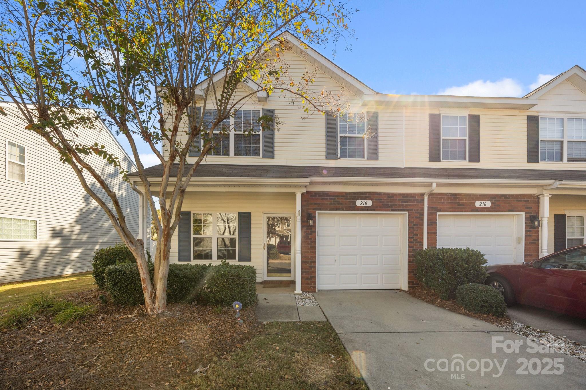 218 Tail Race Lane Fort Mill, SC 29715 - Photo 2 of 42 a front view of a house with a yard and garage
