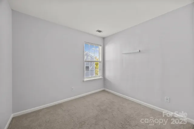 a view of a room with a ceiling fan and a fan