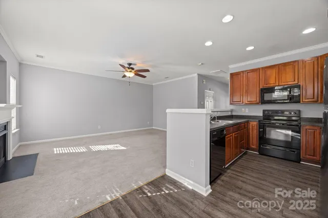 a kitchen with a refrigerator and a stove top oven