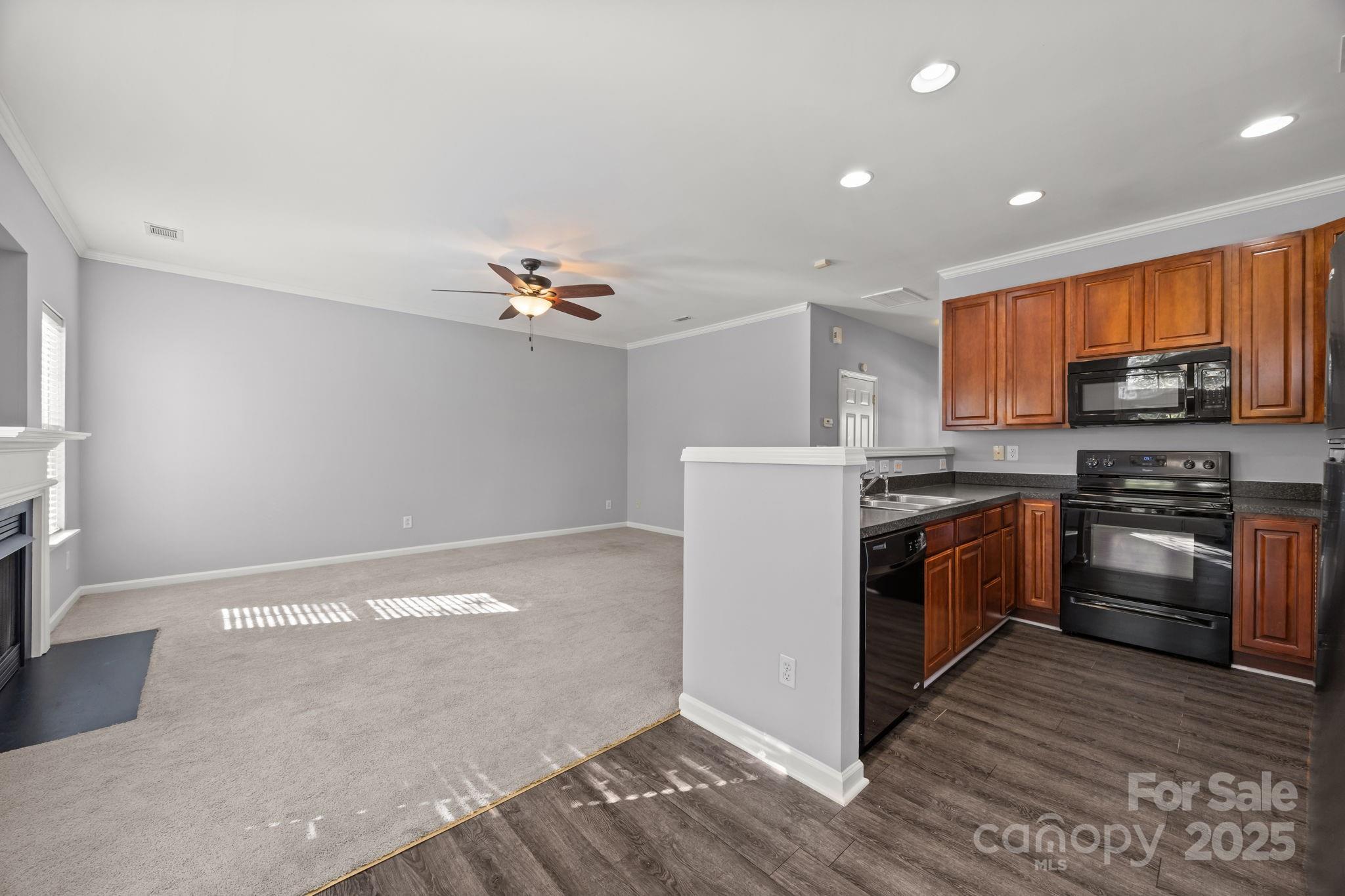 218 Tail Race Lane Fort Mill, SC 29715 - Photo 8 of 42 a kitchen with a refrigerator and a stove top oven