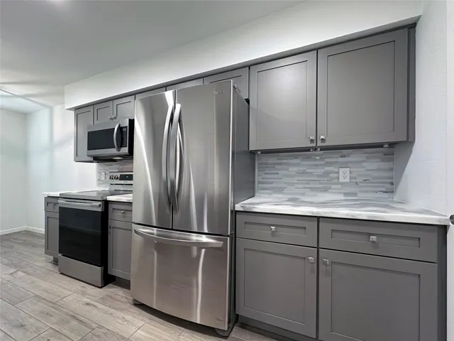 a kitchen with a refrigerator and a sink