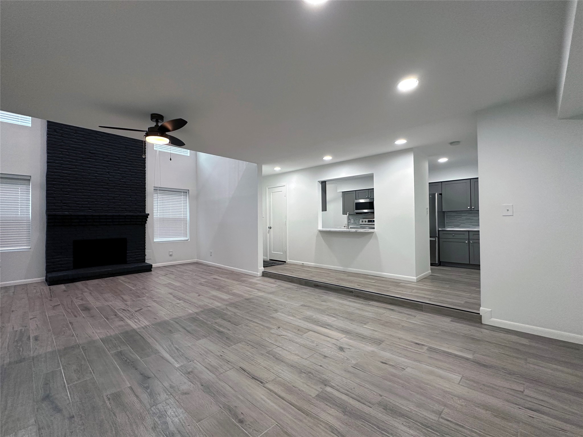 5528 Beverly Hill Street, Unit 3 Houston, TX 77056 - Photo 12 of 50 an empty room with wooden floor and windows