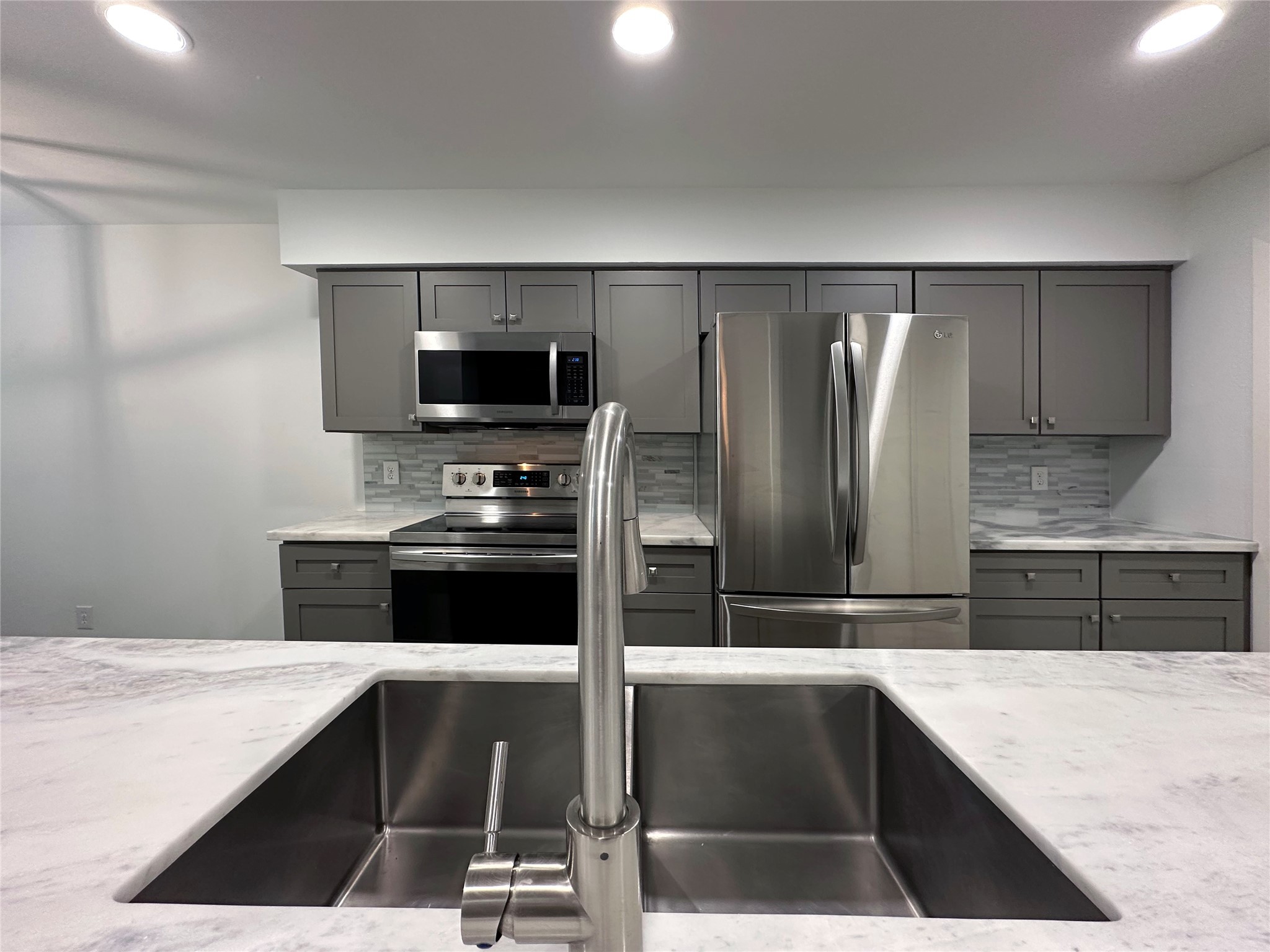 5528 Beverly Hill Street, Unit 3 Houston, TX 77056 - Photo 14 of 50 a kitchen with a refrigerator and a stove top oven