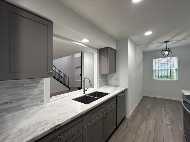 a kitchen with kitchen island a sink stainless steel appliances and cabinets