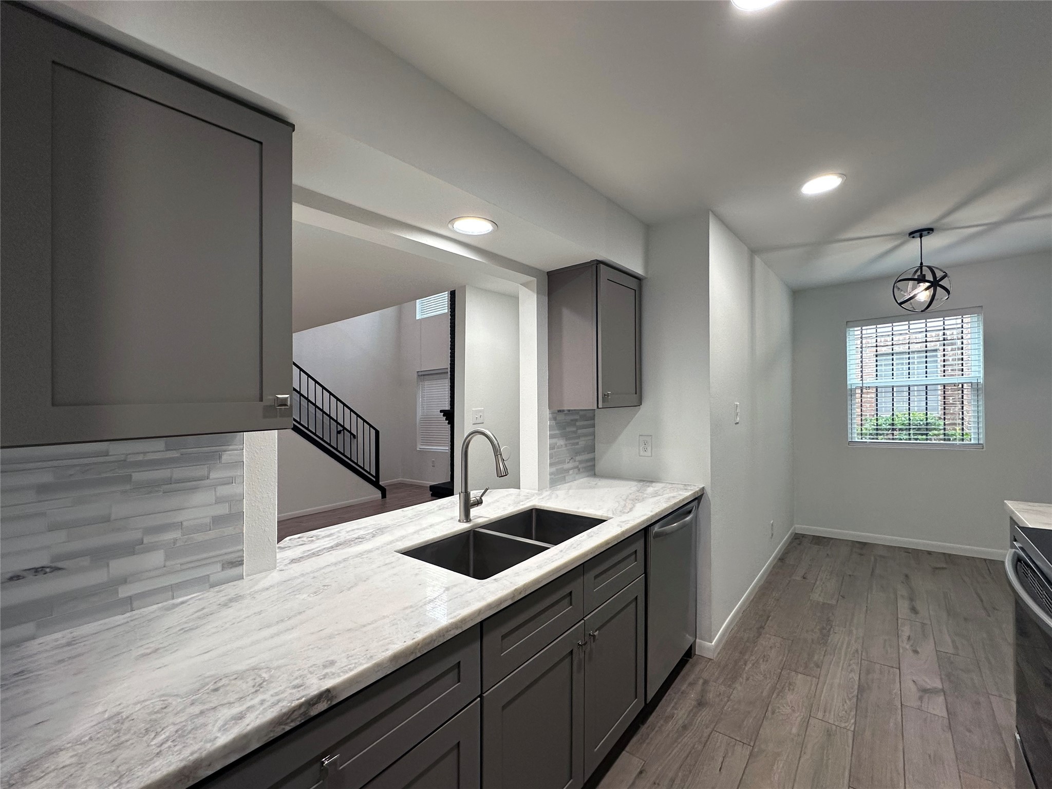 5528 Beverly Hill Street, Unit 3 Houston, TX 77056 - Photo 15 of 50 a kitchen with kitchen island a sink stainless steel appliances and cabinets