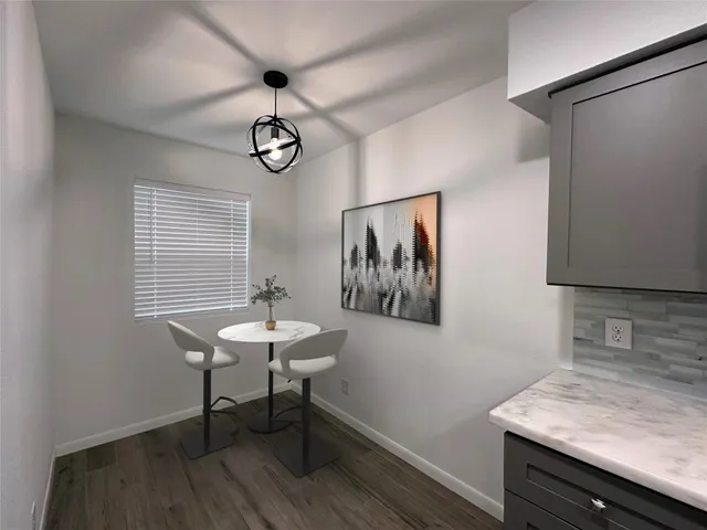 a view of a room with a table and chairs