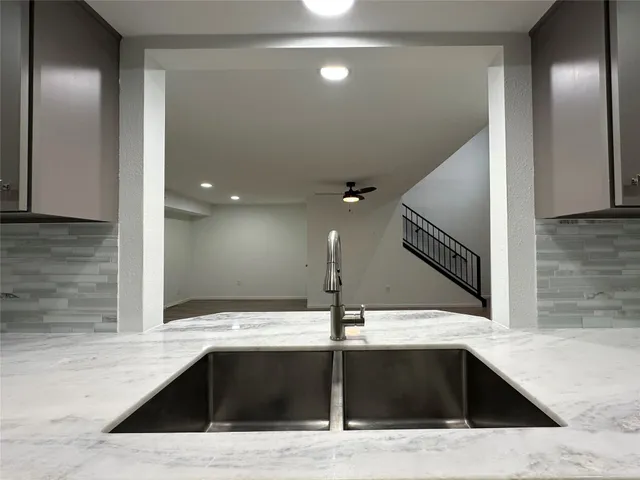 a view of a kitchen with a sink and faucet